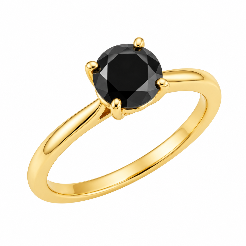 A yellow gold solitaire ring with a round black gemstone in a four-prong setting, shown on a clean white background with a soft reflection below.