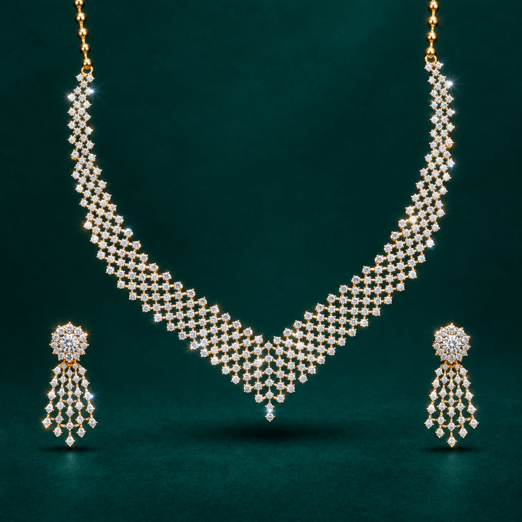 A V-neck necklace set with intricate gold design, accompanied by matching earrings, featuring multiple diamonds.