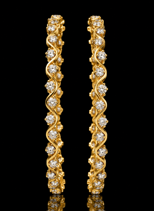 Pair of gold bangles featuring a serpentine wave design studded with round diamonds.
