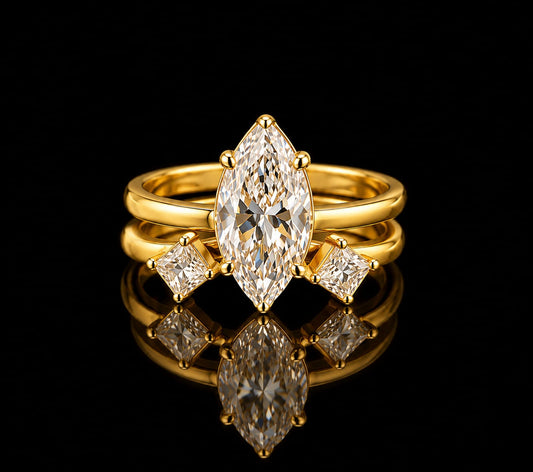 A striking combination of bold geometry and modern elegance. This two-piece ring set features a brilliant Marquise-cut solitaire solitaire paired with an open-cuff companion band set with Kite-cut accent stones, all finished in rich yellow gold.