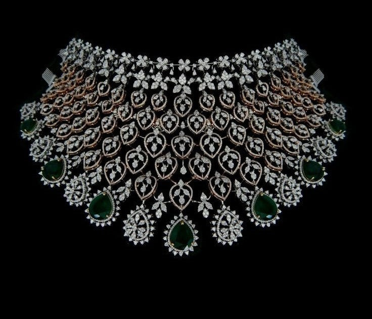 Broad Indian bridal diamond choker with emerald drops, rose gold detailing, and diamond-studded floral motifs set can be made in 9k, 14 and 18k.