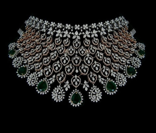 Broad Indian bridal diamond choker with emerald drops, rose gold detailing, and diamond-studded floral motifs set can be made in 9k, 14 and 18k.