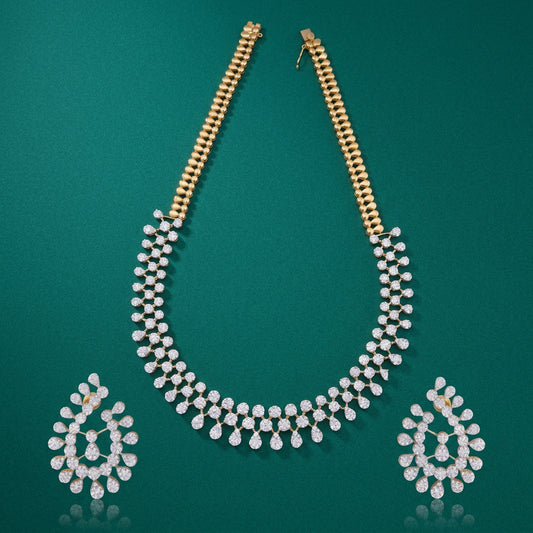 A set of jewelry consisting of a teardrop-shaped diamond necklace and matching earrings, with gold chains and white diamond accents.