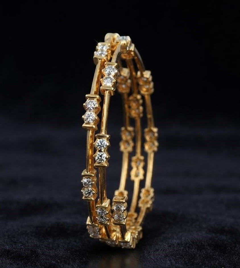 Pair of classic South Indian yellow gold bangles featuring spaced two-stone round lab grown diamond stations along a slender structural metal bar frame.