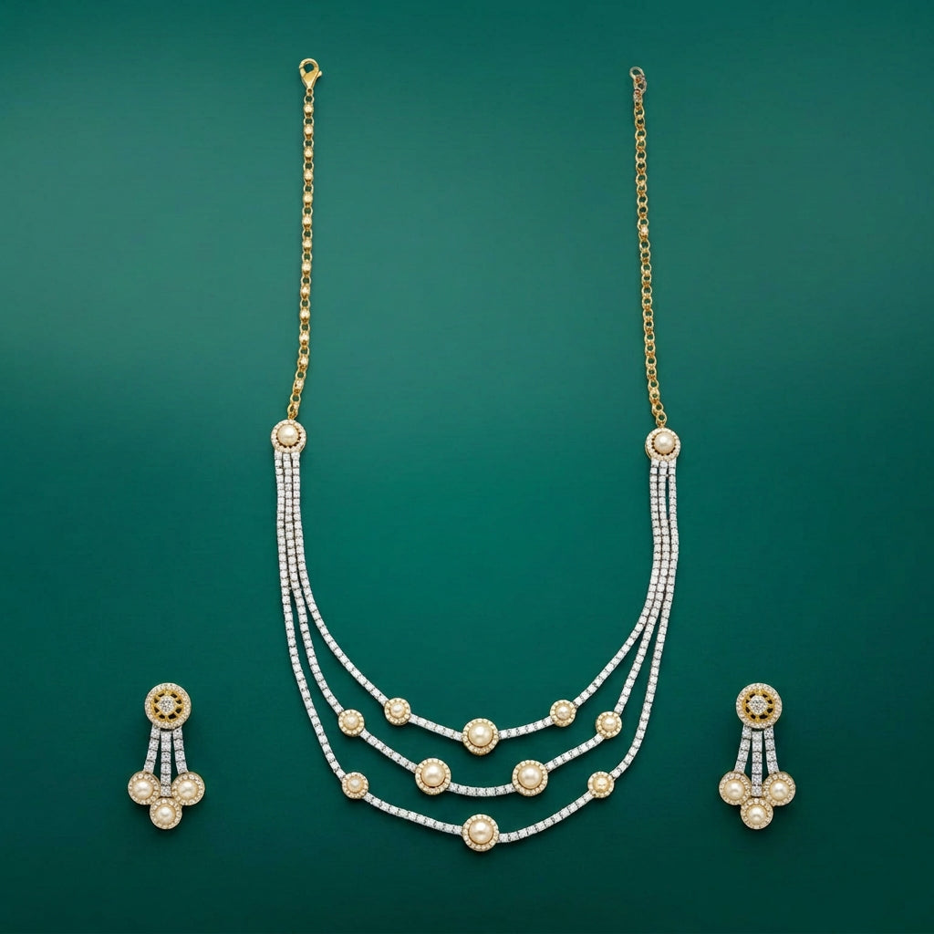 A two-tone, gold and silver-colored necklace with diamond accents, accompanied by a matching pair of earrings.