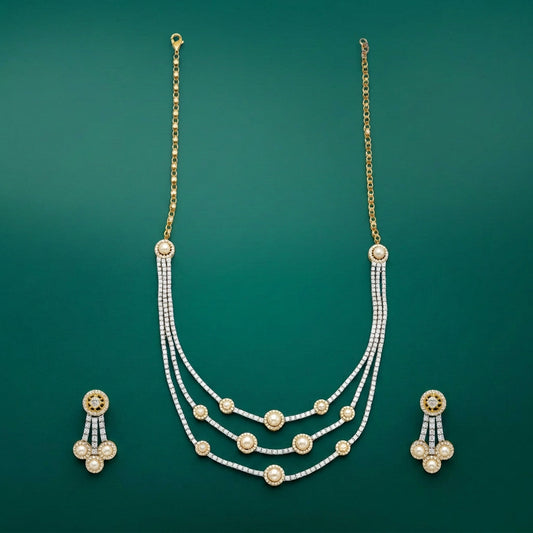 A two-tone, gold and silver-colored necklace with diamond accents, accompanied by a matching pair of earrings.