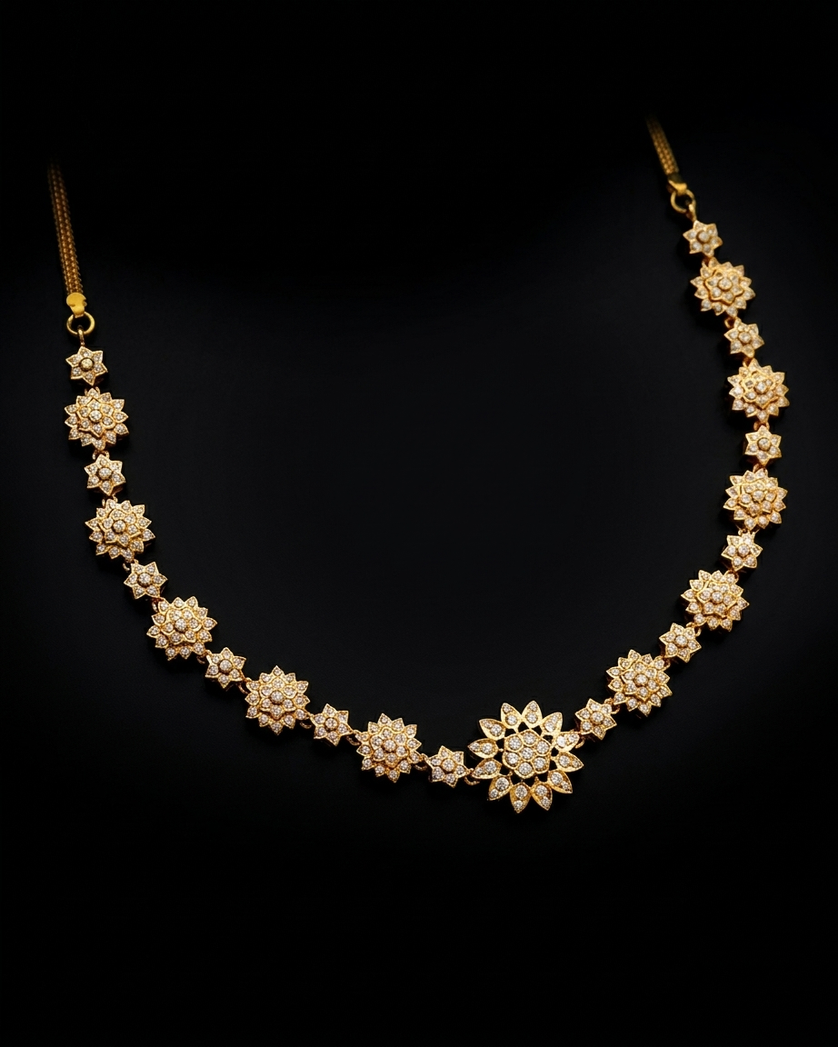 A gold floral necklace with multiple star- and flower-shaped links, each set with small clear stones, displayed on a black background.