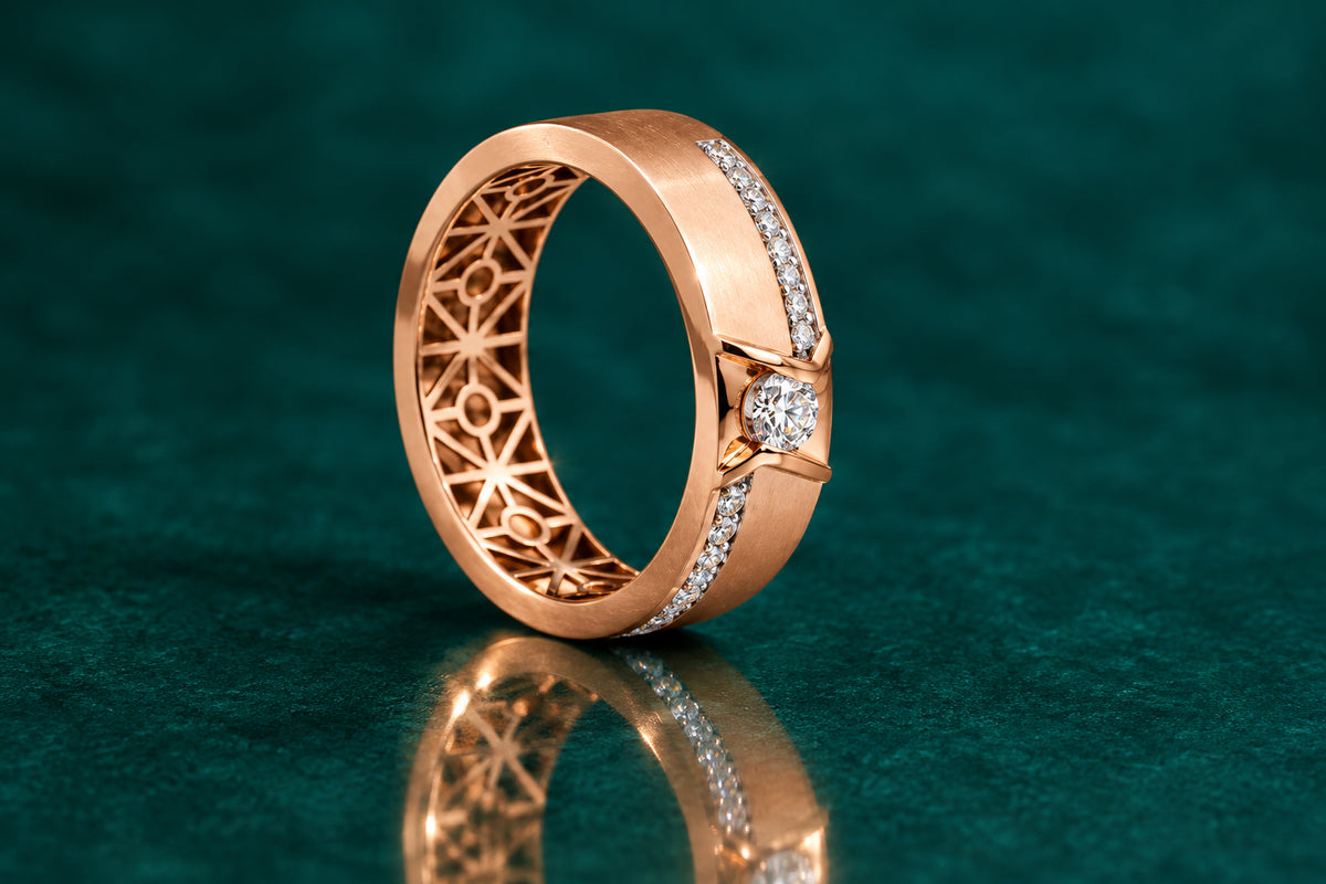 A rose gold couple's ring with diamond accents and a patterned interior.