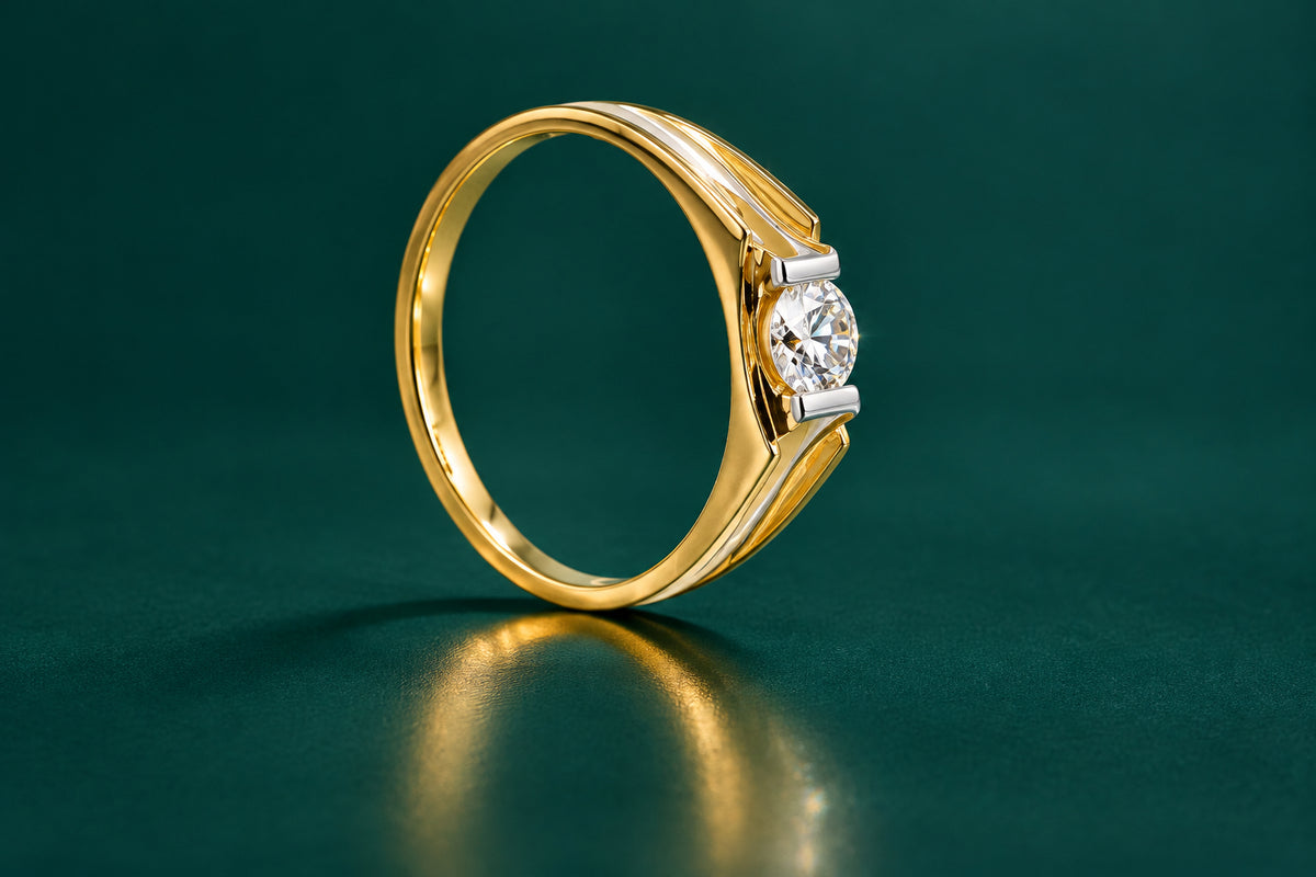 A gold couple's ring set with a prominent diamond in the center, with a smaller diamond on each side.