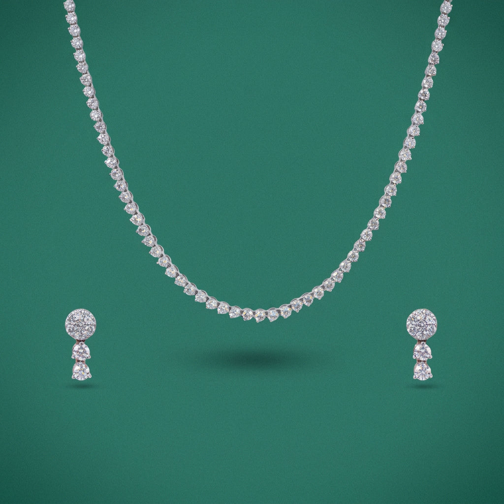 A set consisting of a necklace and earrings with clear diamonds, predominantly gold in color against a white background.